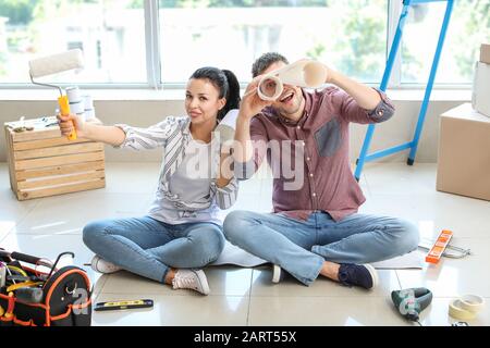 Happy couple having fun during repair in their new house Stock Photo