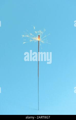 Festive Christmas sparkler on color background Stock Photo
