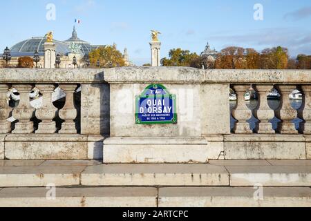 Quai Orsay typical street sign and stone balustrade with Grand Palais view in Paris, France Stock Photo