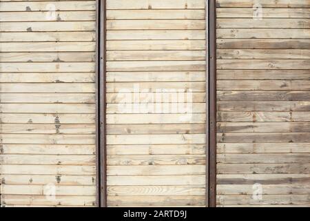 Wooden texture background with horizontal planks and vertical metal bars in sunlight Stock Photo