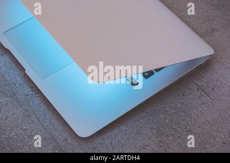 Top view of a laptop with closed lid on an office table. Concept of secrets, hiding and securing information from public access Stock Photo