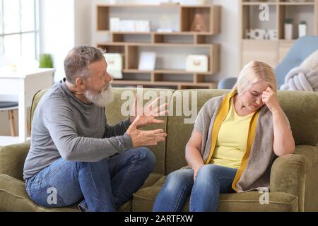 Angry mature couple having arguments at home Stock Photo