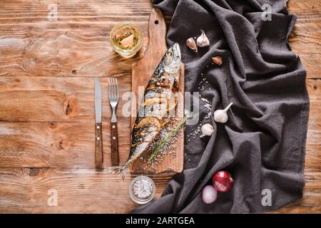 Board with prepared mackerel fish on wooden table Stock Photo