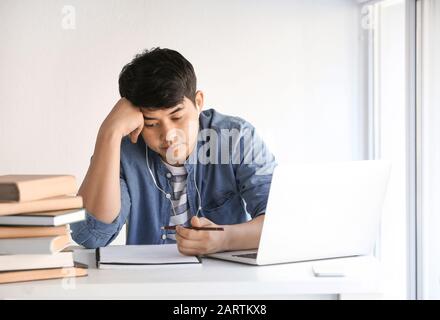 Asian student preparing for exam at home Stock Photo