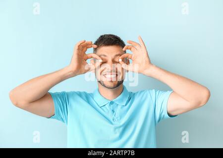 Man with pills on color background Stock Photo
