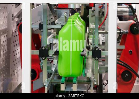 Plastic green cans canister, production of plastic products PVC extrusion method Stock Photo