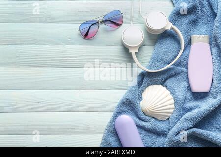 Summer composition with beach accessories, headphones and seashell on wooden background Stock Photo