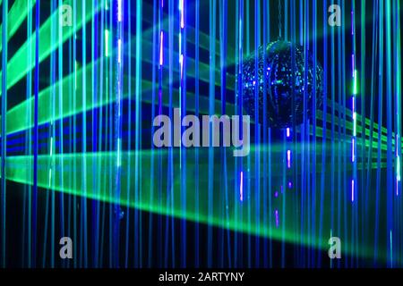 Green and blue laser beams on black background. Laser show rays stream Stock Photo