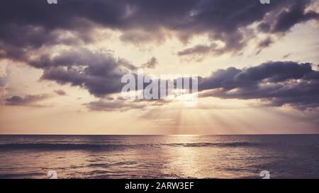 Scenic sunset over the water, color toning applied. Stock Photo