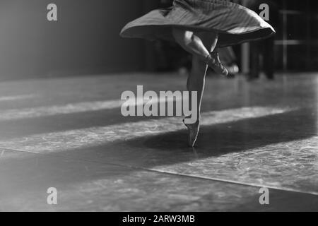 Legs of ballerina dancing in pointe at rehearsal in the hall Stock Photo