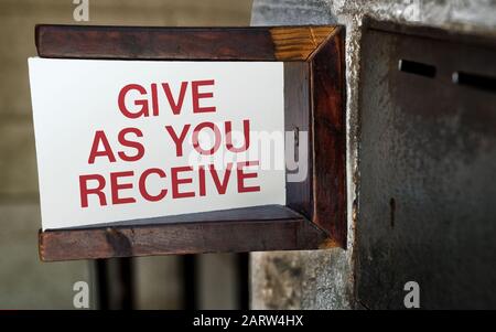 Sign by a church donation box Stock Photo