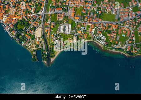 Aerial view of Como lake, Dongo, Italy. Coastline is washed by blue turquoise water Stock Photo