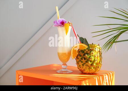 Tasty Pina Colada cocktails on table Stock Photo