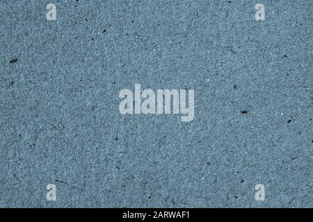Vintage paper texture cardboard background close-up, dark blue grey color. Recyclable material, has small inclusions of cellulose Stock Photo