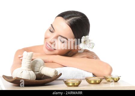 Beautiful young woman with spa items isolated on white Stock Photo