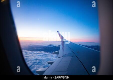 Plane Flying Over Amazing Sunrise Over The Clouds Stock Photo - Alamy