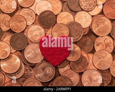 Image full of Euro cents and red heart, copper coin, one and two cents coin will be dismissed by ECB Stock Photo