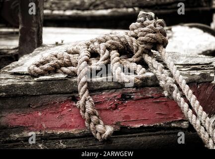 Mooring rope of old wooden narrowboat moored at Portland Basin on the Peak Forest Canal Stock Photo
