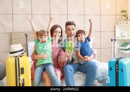 Happy family with packed suitcases at home Stock Photo
