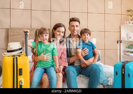 Happy family with packed suitcases at home Stock Photo