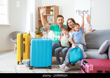 Happy family with packed suitcases at home Stock Photo