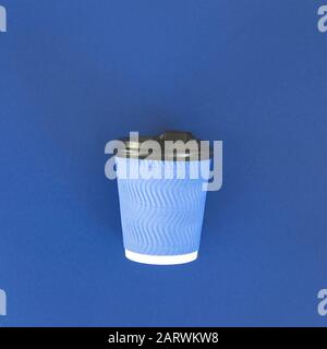 A blue cup of coffee with a black lid on a blue background in the classic color of the year 2020. Stock Photo