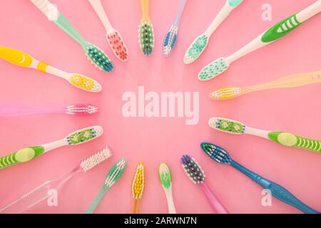 Many different tooth brushes on color background Stock Photo