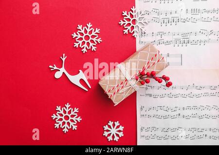 Note sheets, gift and Christmas decor on color background Stock Photo