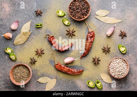 Different spices on grey background Stock Photo