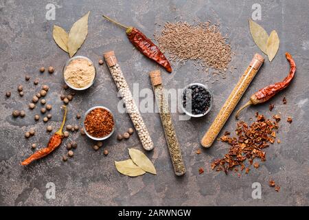 Different spices on grey background Stock Photo