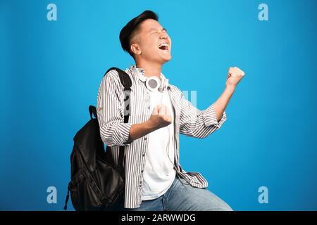 Portrait of happy Asian student on color background Stock Photo