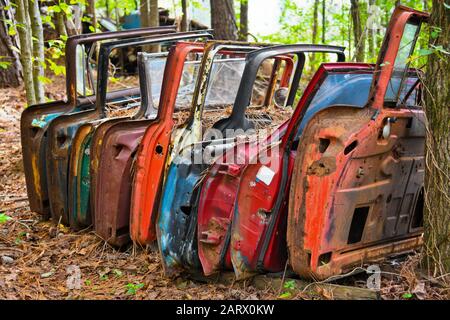 A Row of Old Doors off Scrap Vehicles in a Junk Yard Stock Photo