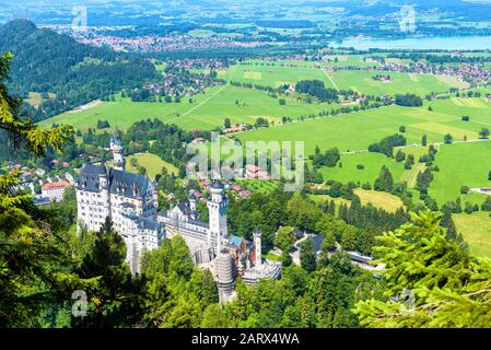 Neuschwanstein castle in Munich vicinity, Bavaria, Germany. This fairytale castle is a famous landmark of German Alps. Landscape with Neuschwanstein c Stock Photo