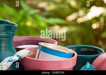 Close up painted flower pots and jug brush 1 paint pot green background  by jziprian Stock Photo