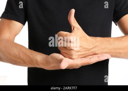 Young deaf mute man using sign language, closeup Stock Photo