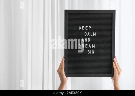 Female hands holding board with motivation phrase Stock Photo