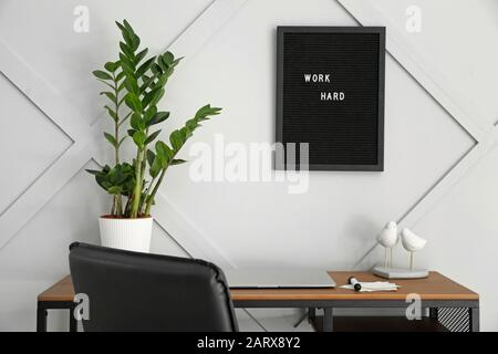 Modern stylish workplace near grey wall Stock Photo