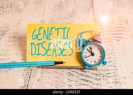 Handwriting text Genetic Diseases. Conceptual photo disease caused by an abnormality in an individual s is genome Mini blue alarm clock stand tilted a Stock Photo