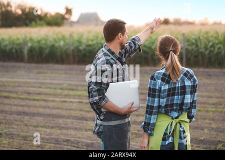 Agricultural engineers working in field Stock Photo