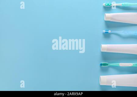 Set of tooth brushes and paste on color background Stock Photo