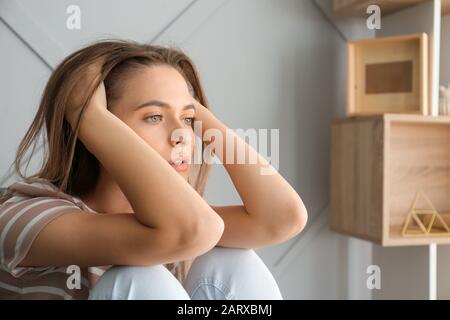 Portrait of depressed woman at home Stock Photo