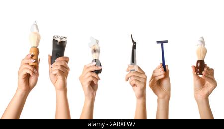 Hands with different tools for shaving on white background Stock Photo
