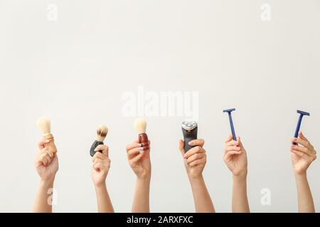 Hands with different tools for shaving on white background Stock Photo