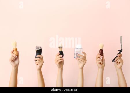 Hands with different tools for shaving on color background Stock Photo