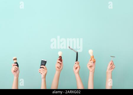 Hands with different tools for shaving on color background Stock Photo