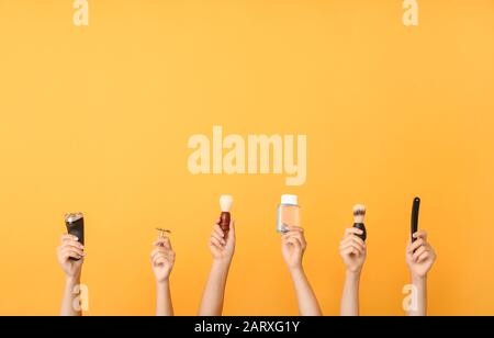 Hands with different tools for shaving on color background Stock Photo