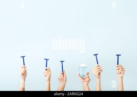 Hands with different tools for shaving on color background Stock Photo