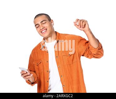 Portrait of handsome young man listening to music on white background Stock Photo