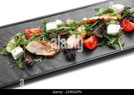 Plate with tasty salad on white background, closeup Stock Photo