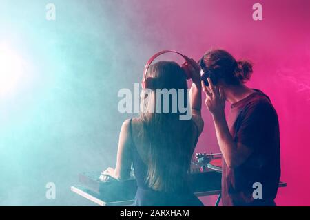 Young djs playing music in nightclub Stock Photo